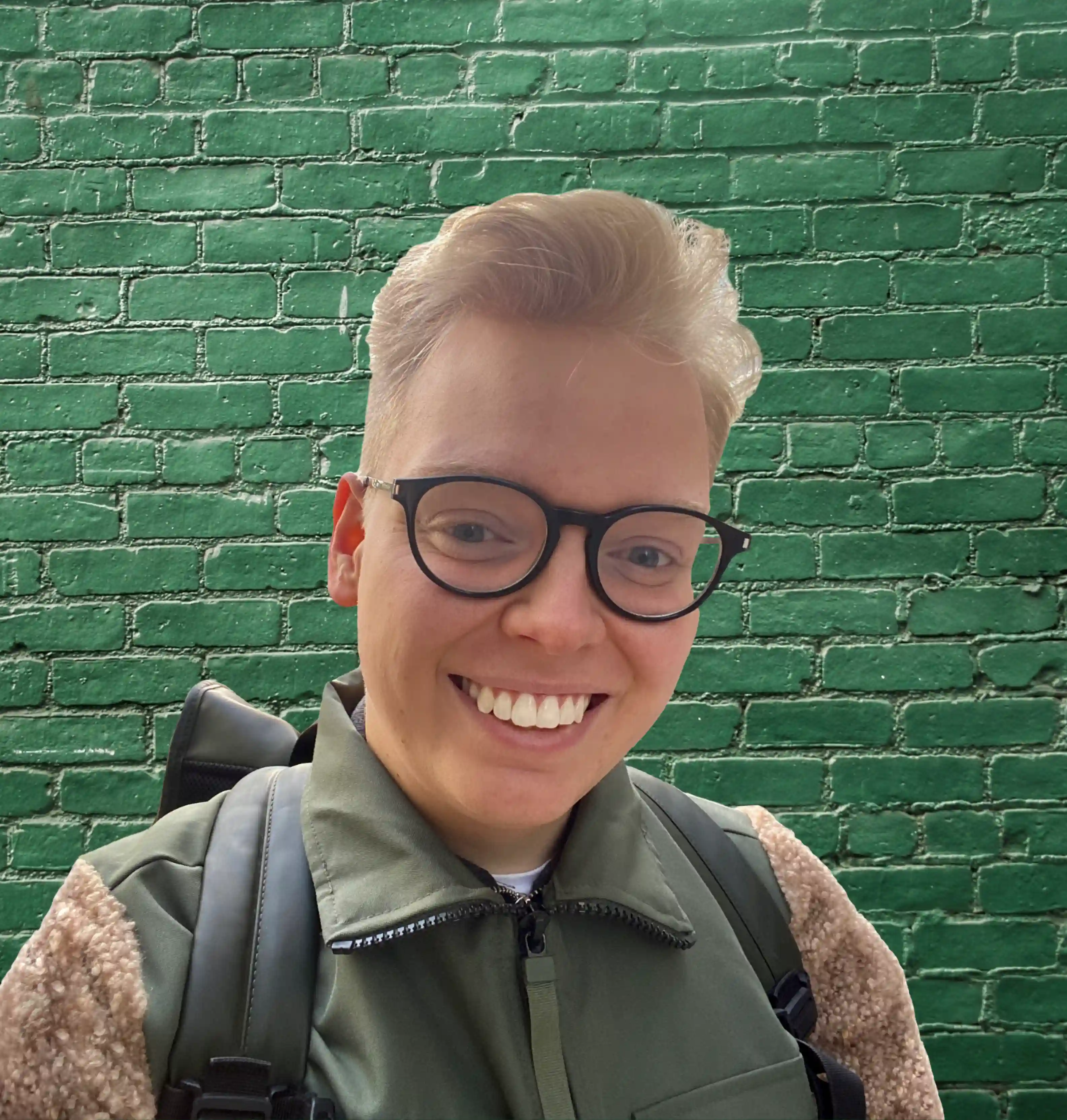 The top half of Arvid Berndtsson in front of a green brick wall